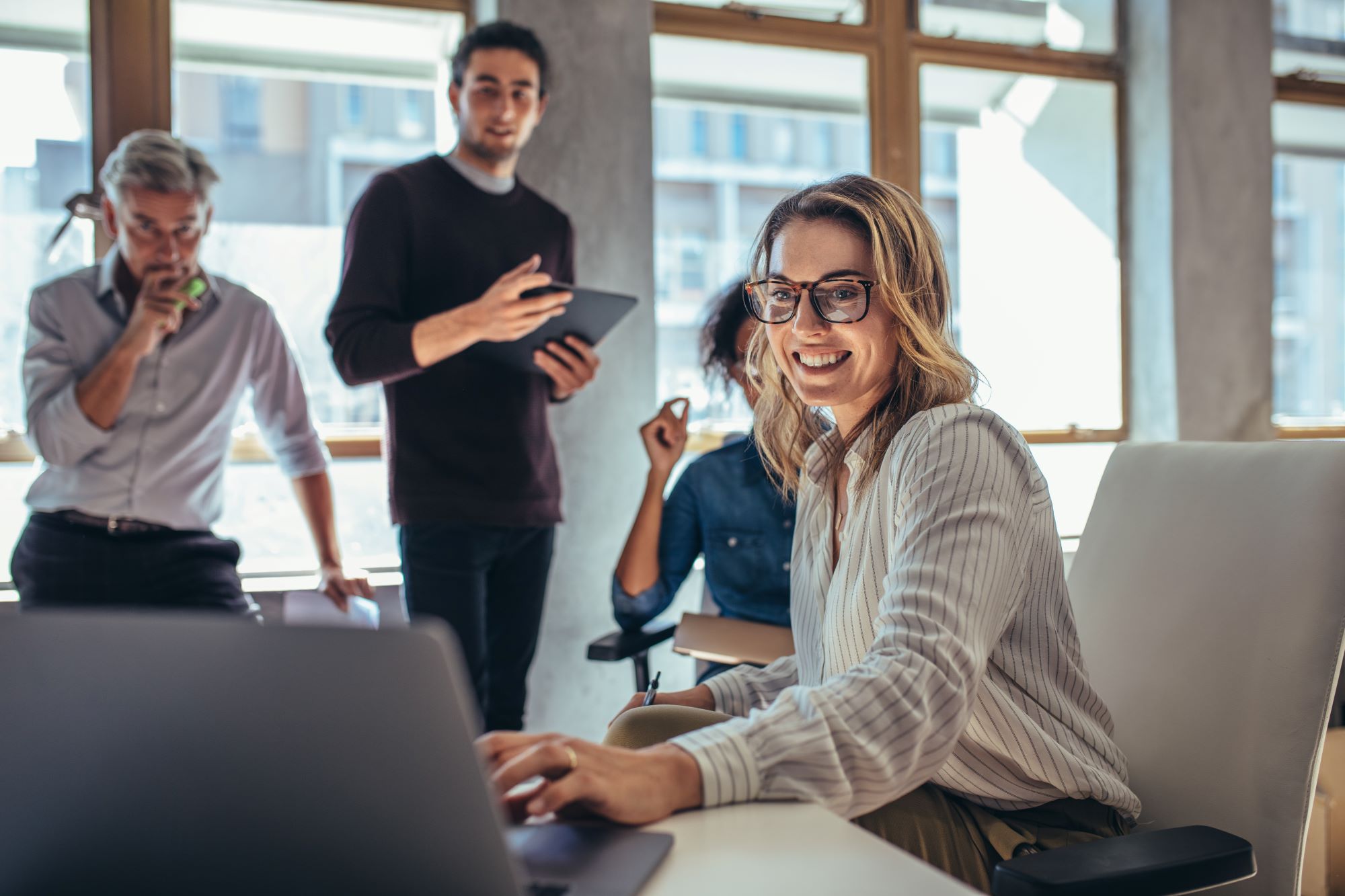Group of colleagues in a office having a discussion 