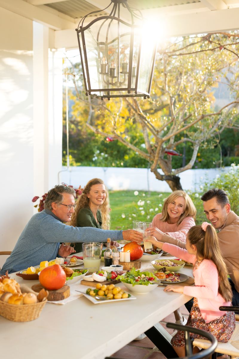 Multi generation family eating outdoor dinner 